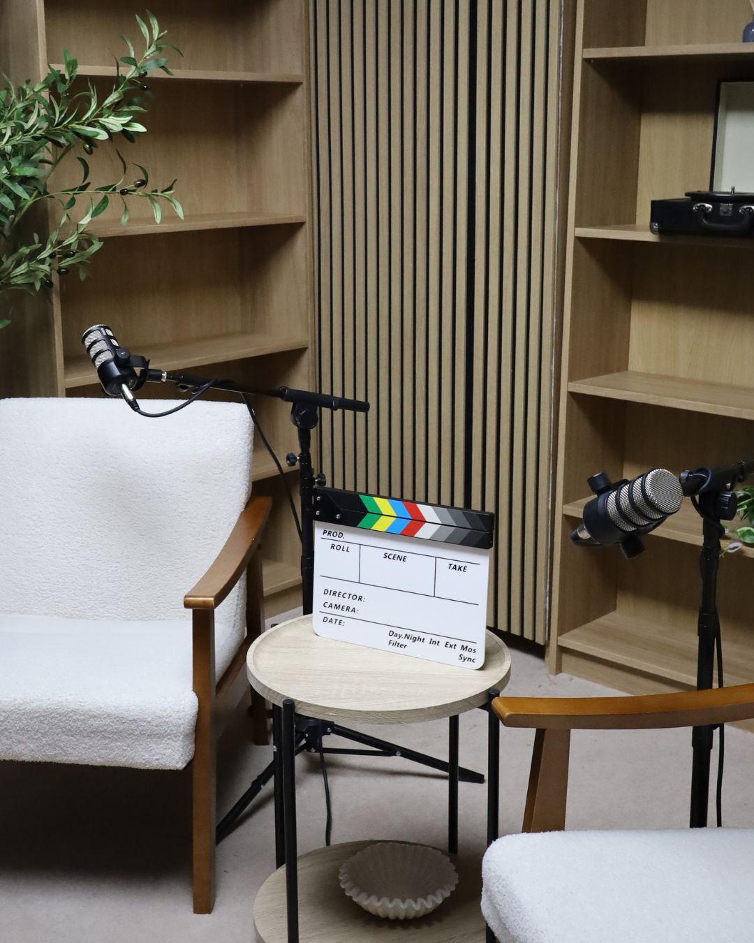 Paragon Creative Studios podcast set with table, chairs and boom microphones